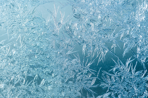 A frost glass with a beautiful natural ice patterns in blue color scheme
