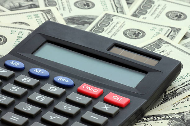 istock calculator on heap of dollars 135895990