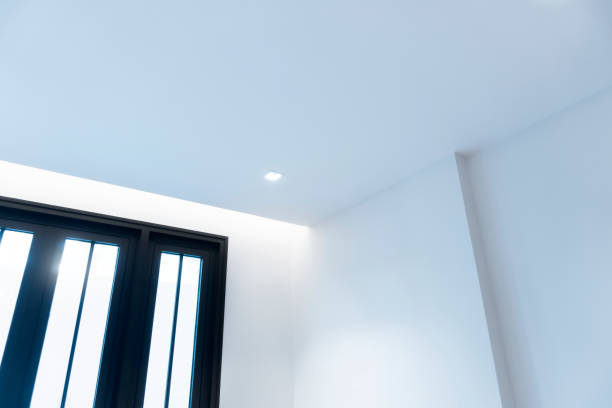 istock white modern room interior hidden LED lighting above window glass. 1358960109