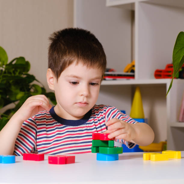 istock A boy of 4 years plays with multi-colored numbers, builds a tower 1358960382