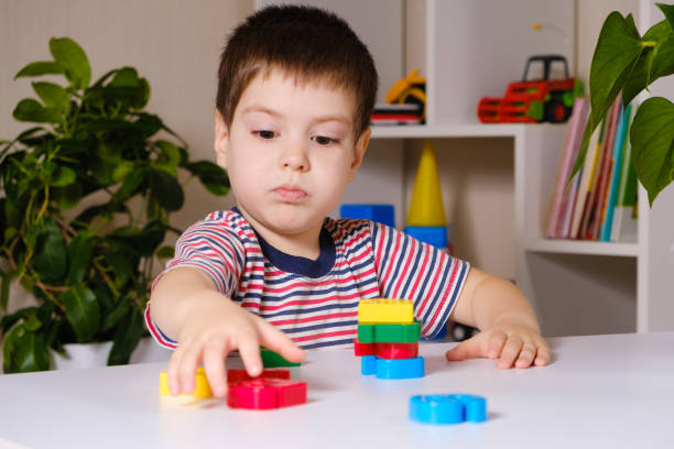 istock A boy of 4 years plays with multi-colored numbers, builds a tower 1358960385