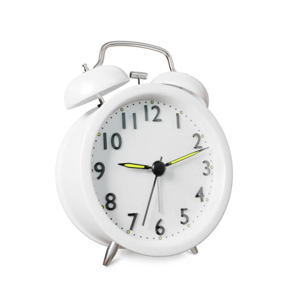 istock Closeup retro white alarm clock isolated on white background 1358960503