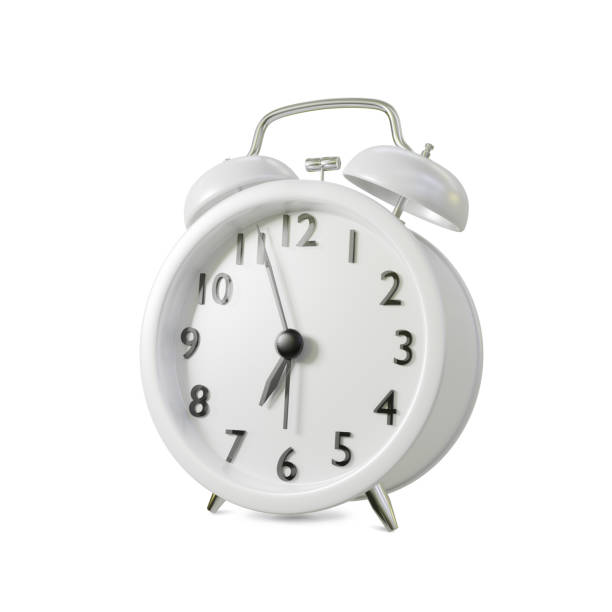 istock Closeup retro white alarm clock isolated on white background 1358960509