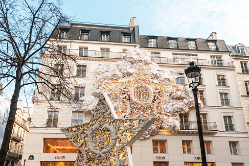 Paris : Christmas decorations on the facade of Dior store, at the corner of Cambon and Saint Honoré streets. Paris Rue Cambon, rue Saint-Honoré. December 9, 2021
