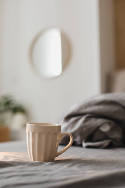 istock a cup on the bed sheets in the morning. coffee in bed 1358963189