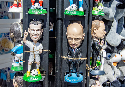 Figurines of Football Players Gareth Bale & Pep Guardiola in Firá on Santorini, Greece, on sale in a gift shop