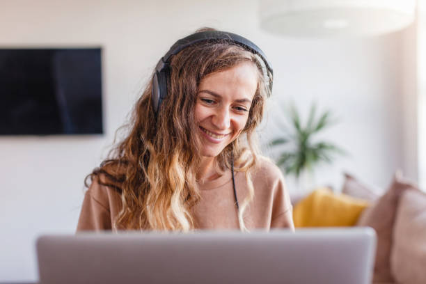 istock Woman in headphones communicates by video call 1358964607