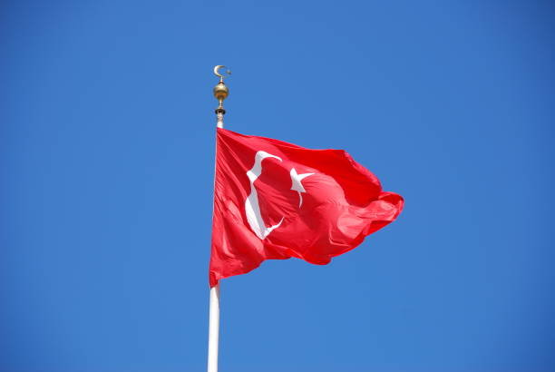 istock Turkish flag flying on the flagpole. Red flag with half moon and star. 1358965017