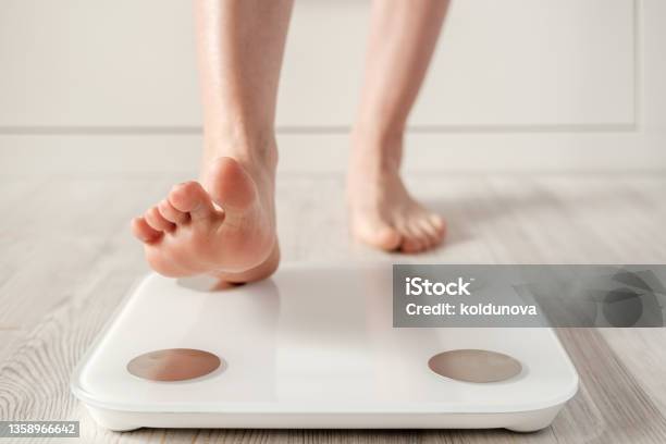 Woman Foot Takes A Step Onto A Smart Scale That Makes Bioelectric Impedance Analysis Bia Body Fat Measurements Stock Photo - Download Image Now
