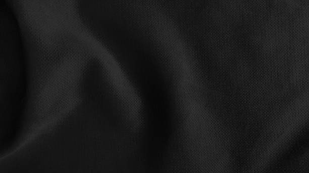 istock close up creased dark black shiny silk fabric texture use as background with space for design. abstract smooth elegant black fabric texture. soft satin silk background with flowing waves. 1358967668