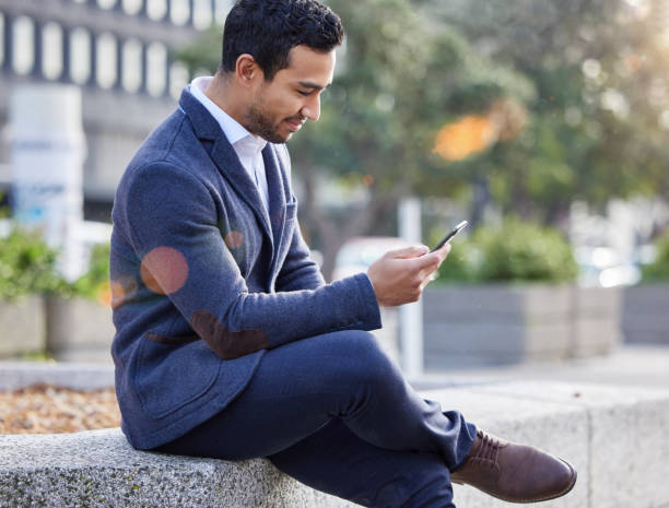 istock Shot of a businessman using his smartphone to send a text 1358967733