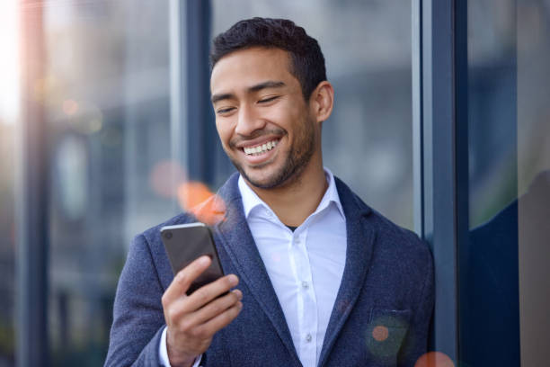istock Shot of a young businessman using his smartphone while outside 1358967777