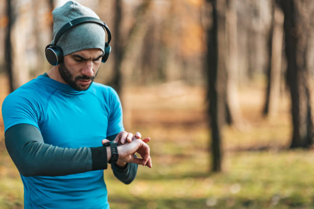 istock Young athletes take a break during exercise in the park and adjust their smart watches. 1358967840