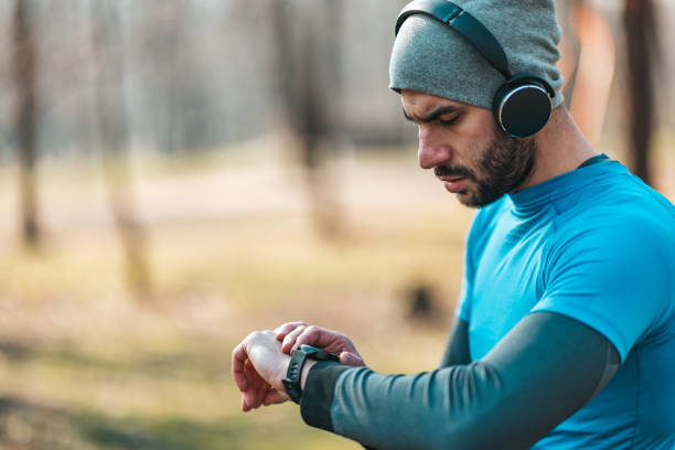 istock Young athletes take a break during exercise in the park and adjust their smart watches. 1358967850