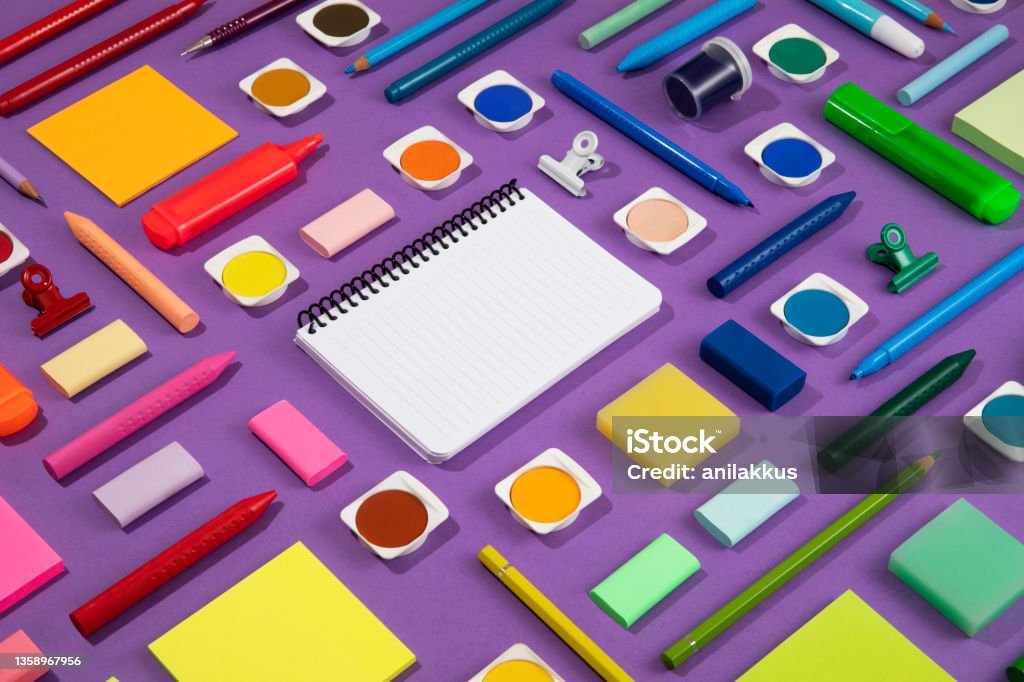 School Supplies Knolling Back to school concept with crayons and school supplies on purple background Group Of Objects Stock Photo