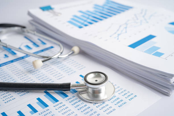 istock Stethoscope on spreadsheet paper, Finance, Account, Statistics, Investment, Analytic research data economy spreadsheet and Business company concept. 1358968013