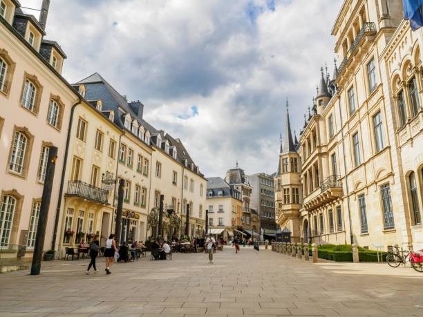 view of the Rue du Marche-aux-Herbes with the main facade of the Grand Ducal Palace on the right Luxembourg city, Luxembourg - August 10, 2021: view of the Rue du Marche-aux-Herbes with the main facade of the Grand Ducal Palace on the right luxemburg stock pictures, royalty-free photos & images