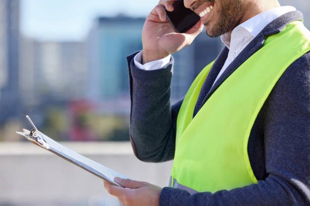 istock Shot of a businessman using his smartphone on a construction site 1358968975