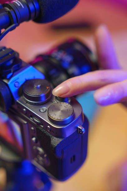 istock A woman sets up a shooting camera in a studio with a bright light, we see it from a top view 1358969182