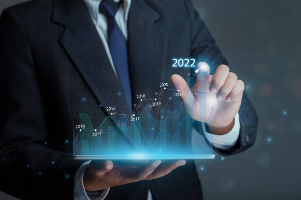 istock Businessman holding tablet with draws increase arrow graph corporate future growth year 2021 to 2022. Development to success and growth business concept. 1358970317