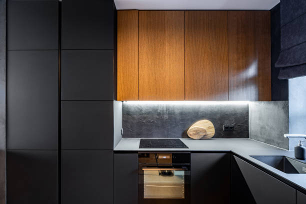 istock Modern kitchen with black cabinet facades 1358970532