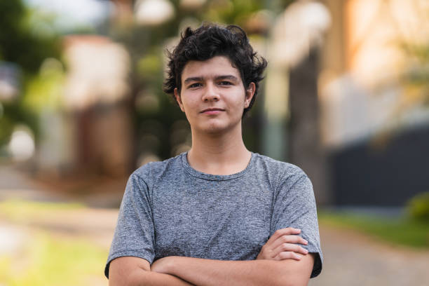 istock Front view of a boy looking serious at the camera 1358970991