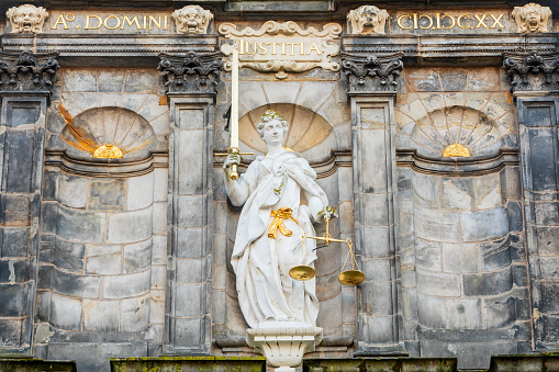 sculpture of Lady Justice on the facade of the town hall of Delft in the Dutch province of South Holland; Delft, Netherlands