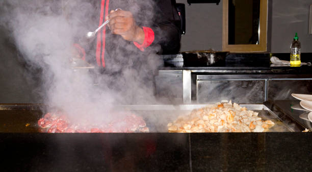 istock cook seasoning meat on the steaming griddle 1358972435