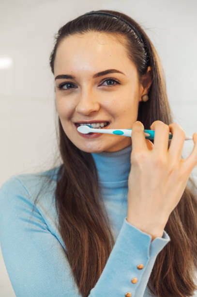 istock Beautiful caucasian girl brushing her teeth 1358973559