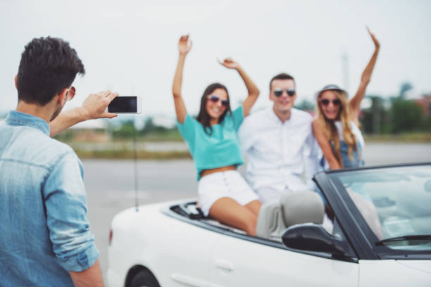 istock Friends in cabriolet 1358973818