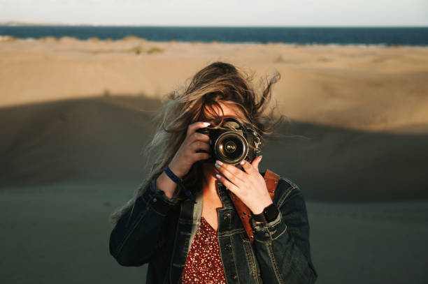 istock Female photographer taking a photo 1358975244