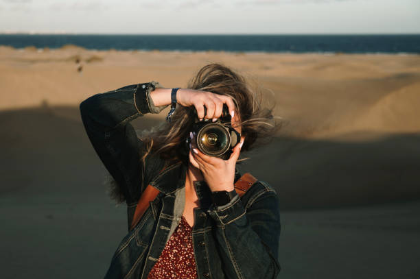 istock Female photographer taking a photo 1358975328