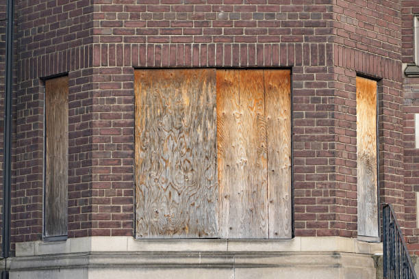 istock old abandoned apartment building with boarded up windows 1358978032