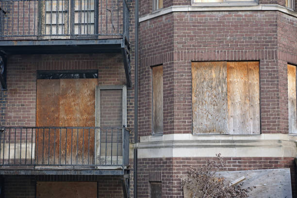 istock old abandoned apartment building with boarded up windows 1358978041