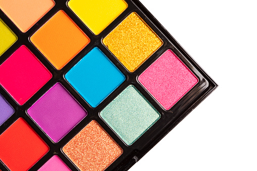 A close up image of a colorful eye shadow palette.