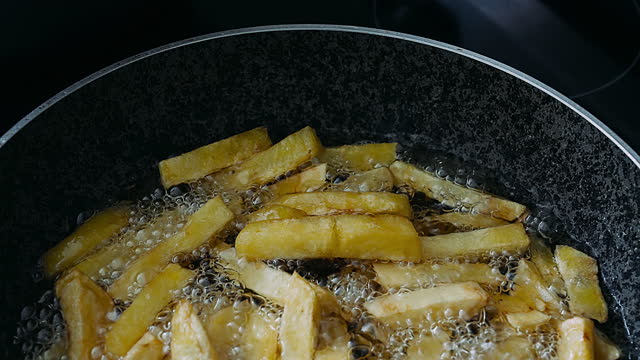 French fries cooking on a pan