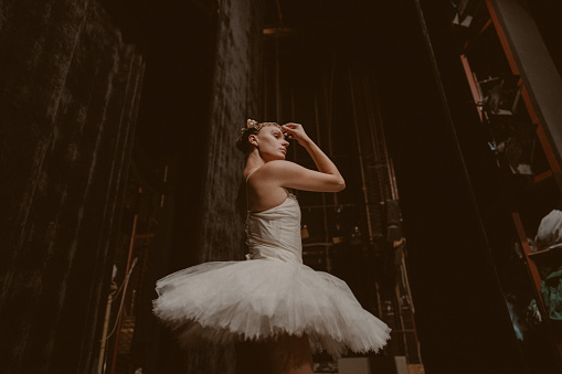 Photo of a ballet dancer backstage having the last preparations before her performance.