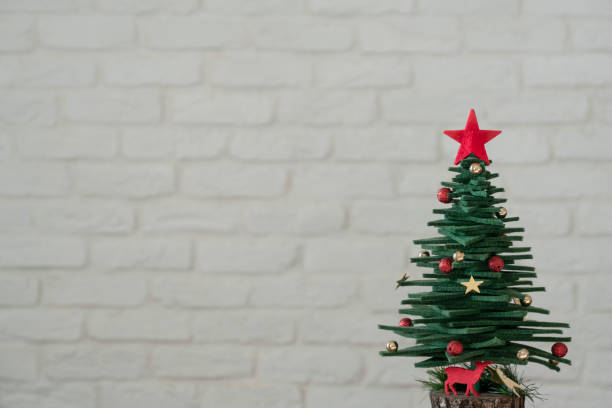 istock New year background with pine tree over white brick wall with copy space 1358982106