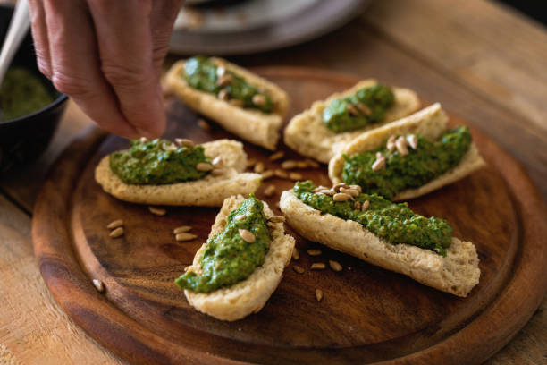 istock Green ramson pesto with almond on bread pieces, close-up 1358983301