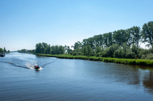 istock A pleasure boat travelling down a canal. 1358986400