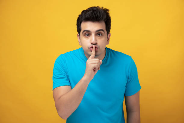 young man, stock phooto Indian, adult, student, man, lifestyle, finger on lips stock pictures, royalty-free photos & images