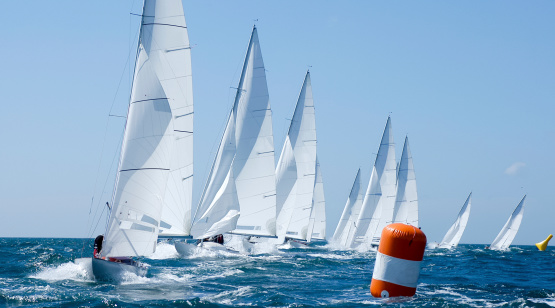 group of dragon yacht in regatta near a  buoy