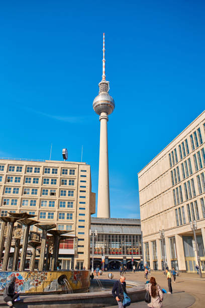 alexander platz berlin's central city square - clock station people berlin germany imagens e fotografias de stock