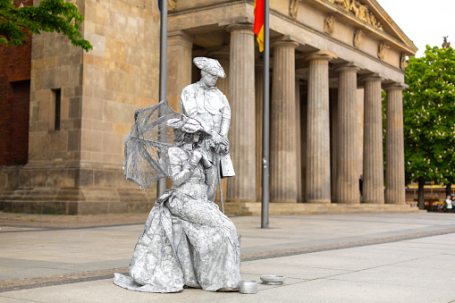 Art performance actors play statues on a city street. Berlin, Germany - 05.17.2019