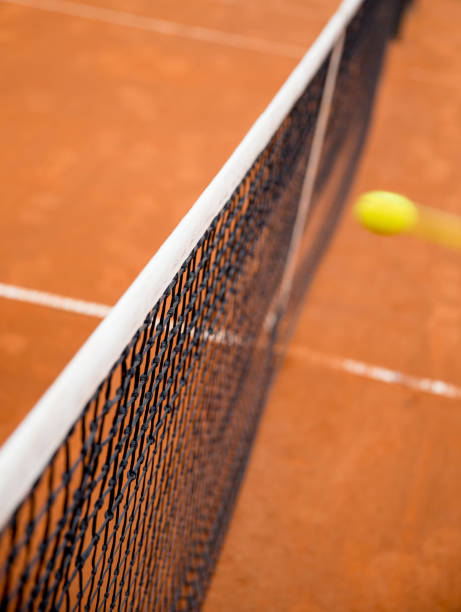 istock Fast ball on a tennis service flying to the net 1358990504