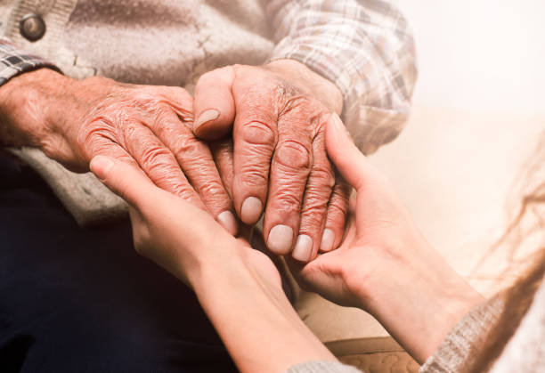 istock young hands holding the hands of an elderly man 1358991196