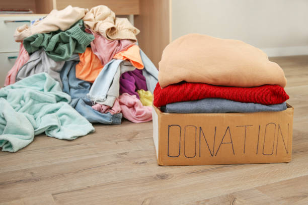 istock Donation box with warm clothes in the room. 1358991704