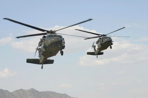 Two Black Hawk Helicopters in formation.