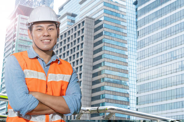 istock Factory engineer man standing confidence in front of building facade. construction workers for modern architecture in a city. 1358993611