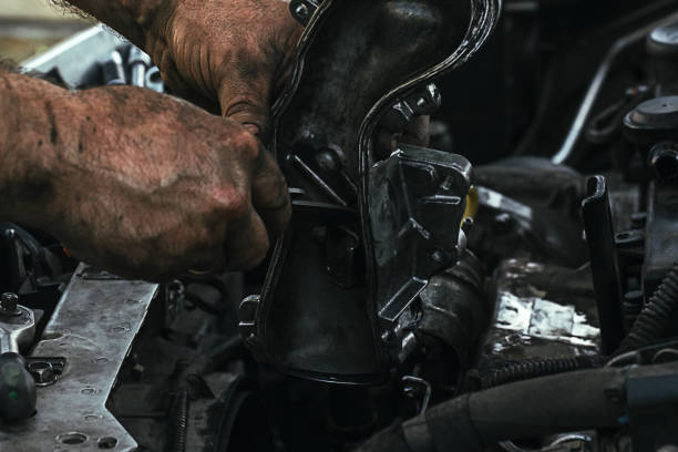 dirty, greasy hands of a man repairing the engine, EGR valve in the car close up stock photo